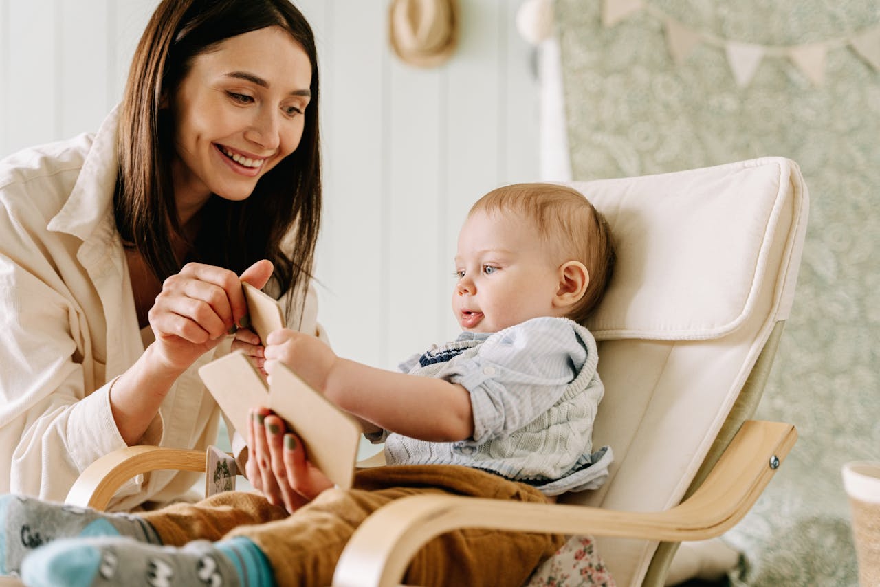 A mother reading a book with her baby, sharing moments of joy and learning.